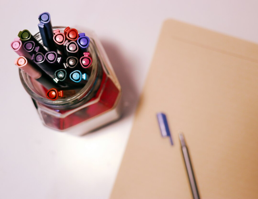 Stack of printed documents and a pen on a desk
